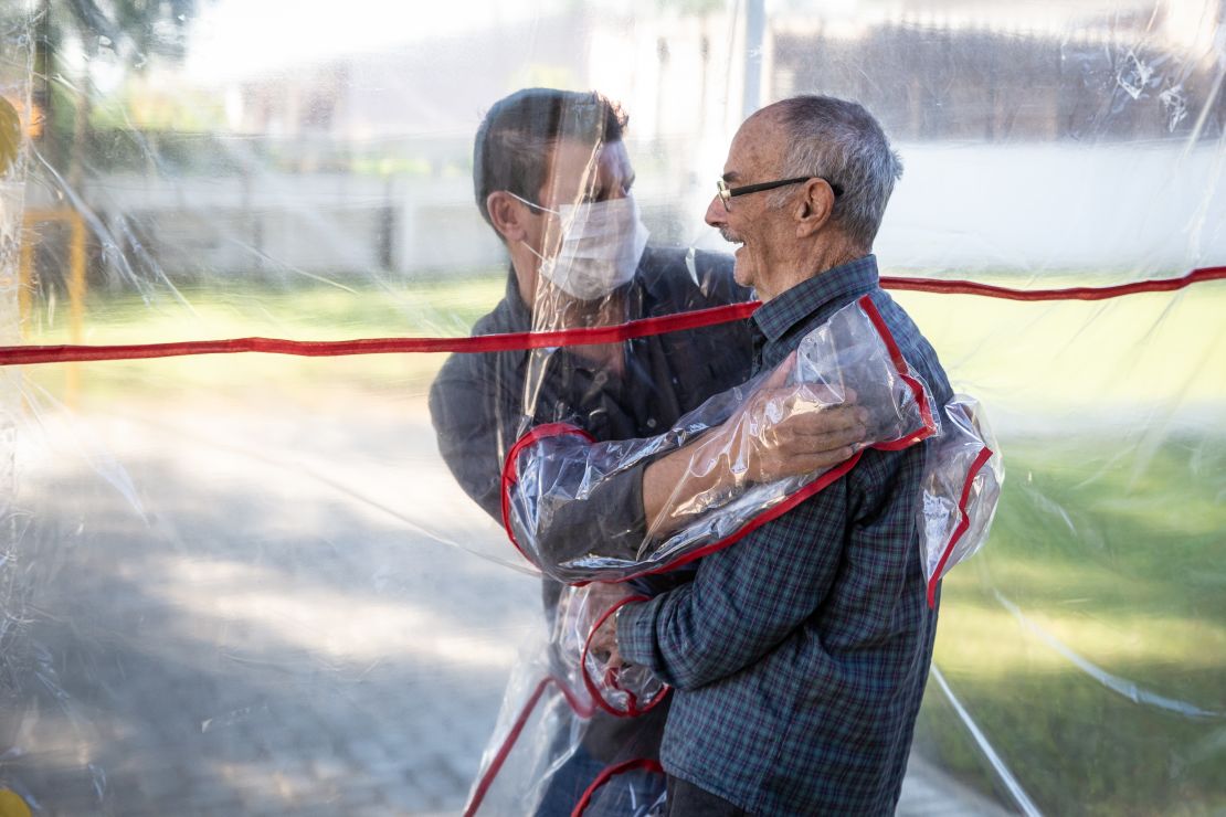 The "hug tunnel" allows the clinic's elderly residents to hug relatives after more than 70 days apart.