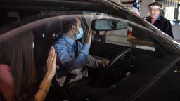 Charbel Abdo Habib of Rochester Hills and his wife Rana El-hachem, originally from Lebanon, raise their hands as Federal Magistrate Judge Patricia Morris of Bay City swears them in as new citizens individually from a podium during a drive-thru service in a parking structure at the U.S. Citizenship and Immigration Services headquarters on Detroit's east side on Wednesday, June 17, 2020 as a way to continue working as the federal courthouse is shut down due to Coronavirus.