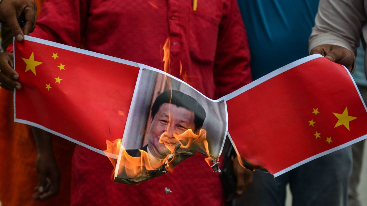 TOPSHOT - Bharatiya Janata Party (BJP) supporters burn posters and effigy of Chinese President Xi Jinping during an anti-China protest in Allahabad on June 17, 2020. - India and China held top level talks on June 17 to "cool down the situation", Beijing said, after a violent border brawl that left at least 20 Indian soldiers dead. (Photo by SANJAY KANOJIA / AFP) (Photo by SANJAY KANOJIA/AFP via Getty Images)