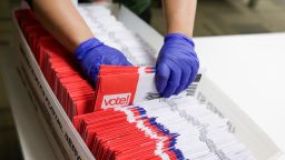 Election workers sort vote-by-mail ballots for the presidential primary at King County Elections in Renton, Washington on March 10, 2020. 