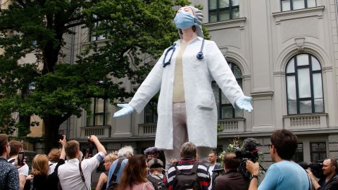 Latvian artist Aigars Bikše unveils a statue honoring the health care workers battling Covid-19.