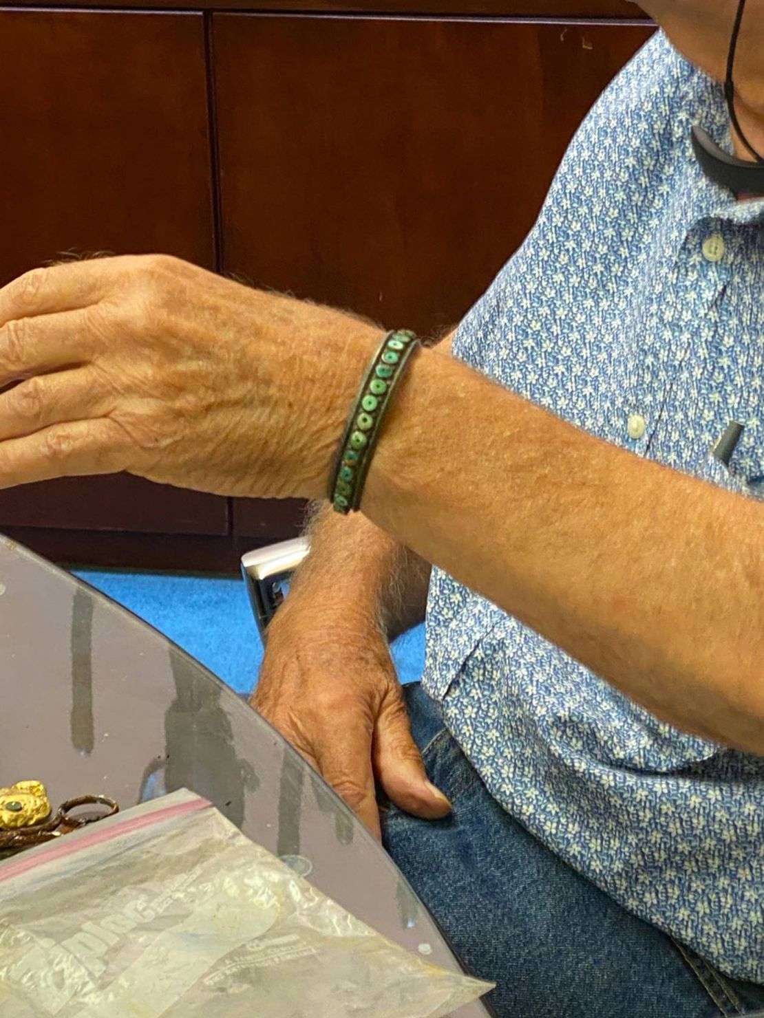 Fenn wearing a bracelet made of silver, which has been tarnished black.