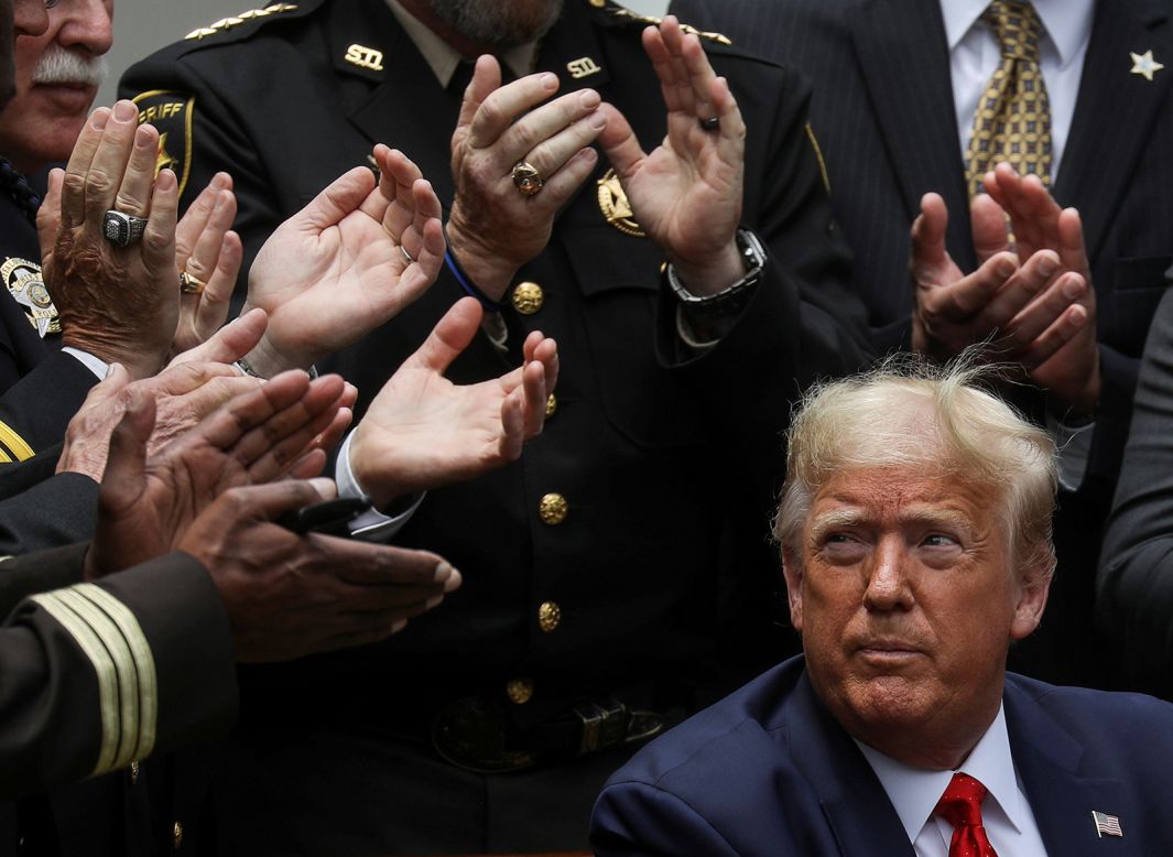 US President Donald Trump listens to applause after signing an executive order on police reform Tuesday, June 16, in the White House Rose Garden. Trump said he was <a href="https://www.cnn.com/2020/06/16/politics/police-reform-order-donald-trump/index.html" target="_blank">taking executive action</a> to encourage police to adopt the "highest and the strongest" professional standards "to deliver a future of safety and security for Americans of every race, religion, color and creed." <a href="https://www.cnn.com/2020/06/16/_politics-zone-injection/trump-police-reform-eo/index.html" target="_blank">His order,</a> among other steps, creates a federal database of police officers with a history of using excessive force.