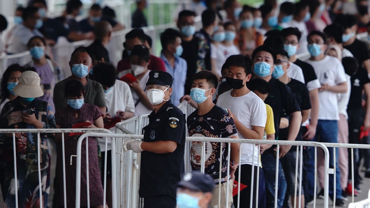 People who have had contact with the Xinfadi market line up for coronavirus tests at a testing center on June 17.