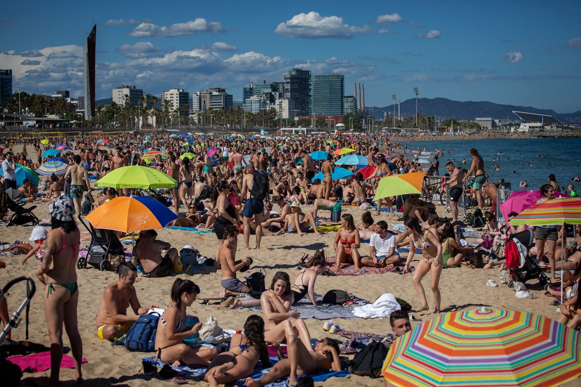 People crowd a beach in Barcelona, Spain, on Saturday, June 13, as coronavirus restrictions have been relaxed.