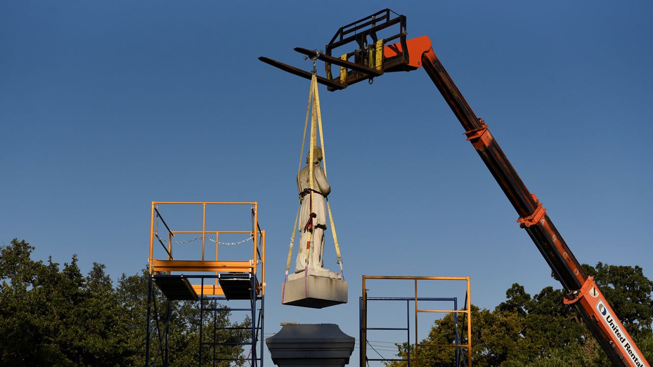A statue of Confederate Commander Richard W. Dowling is removed in Houston, Texas, on June 17, 2020. 