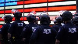 NYPD police officers watch demonstrators in Times Square during a Black Lives Matter protest on June 1, 2020.