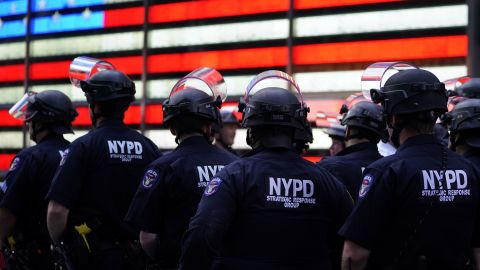 New York police officers watch demonstrators in Times Square during a Black Lives Matter protest on June 1, 2020.
