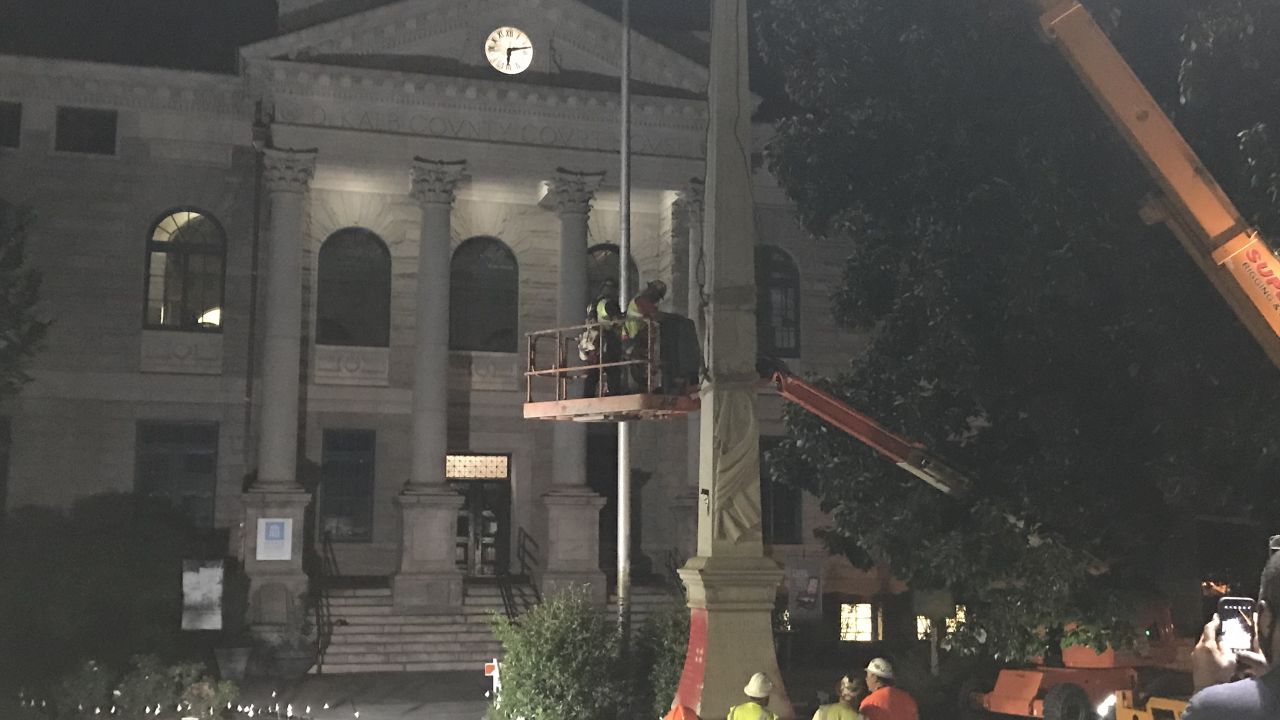 A crane removes a Confederate monument from Decatur Square in Georgia on Thursday night. 