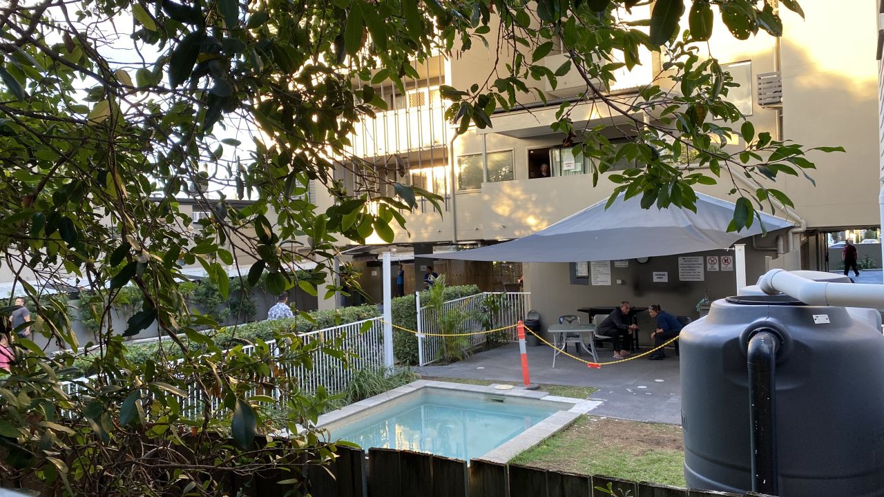 Temporary fences have been erected around the hotel, but the neighbors can see into the hotel grounds from their kitchen.