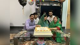 Malala Yousafzai, who survived a Taliban assassination attempt as a child in Pakistan before moving to England, celebrates completing university with her family.