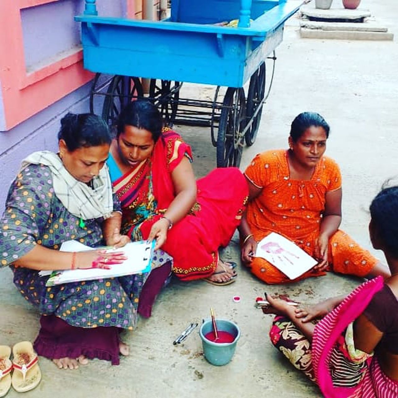 Participants in the Red Wall project write their stories. Kalki sees the red painted palms signifying "a slap against abusers and a sign of resistance."
