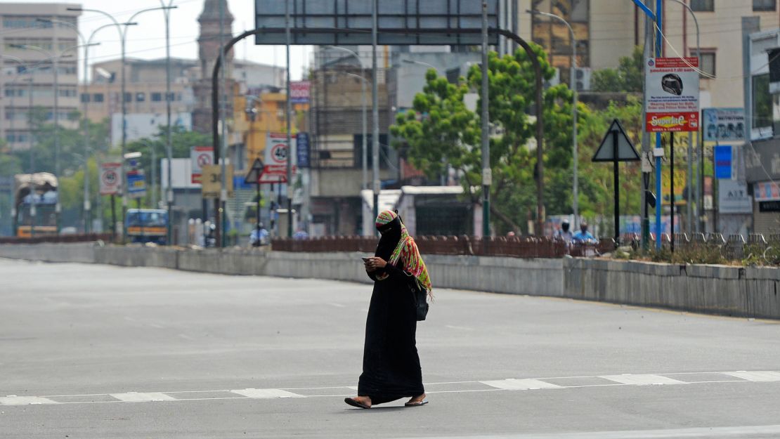 A woman walks through a deserted road as lockdown measures were re-imposed to contain the spread of Covid-19 in Chennai, India on June 19, 2020. 