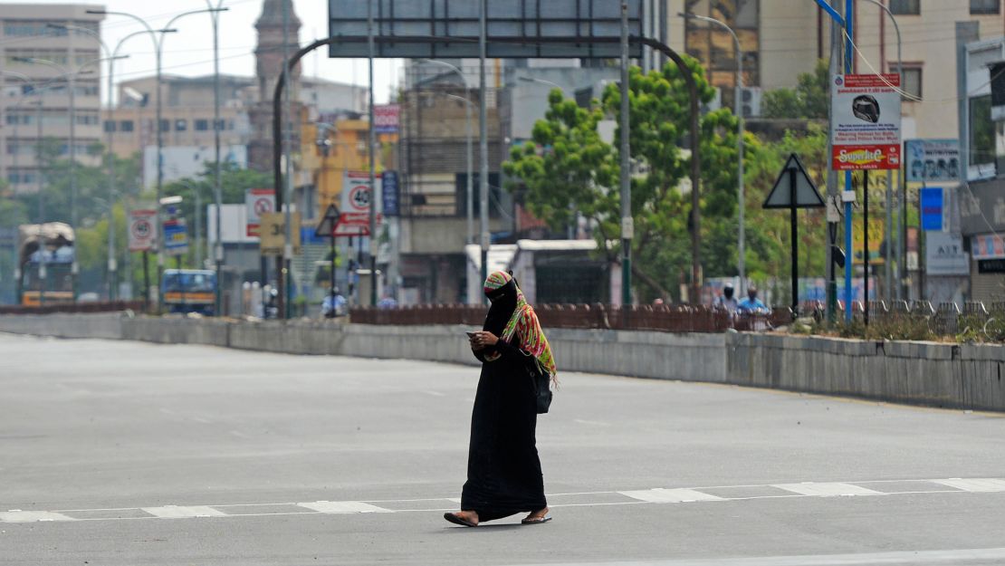 A woman walks through a deserted road as lockdown measures were re-imposed to contain the spread of Covid-19 in Chennai, India on June 19, 2020.