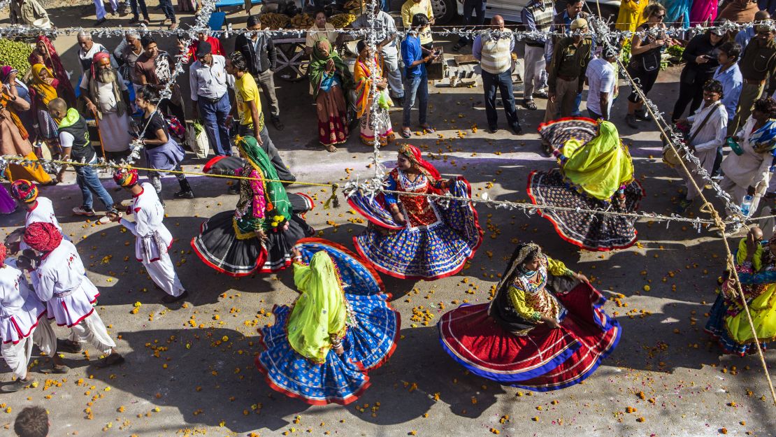 Folk dancers dressed as various deities perform in a procession through a street during the Pushkar Camel Fair in Pushkar, Rajasthan, India, on Sunday, Nov. 22, 2015.