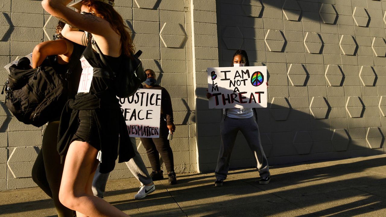 A woman holds a protest sign in Oakland, California, on June 1, 2020.