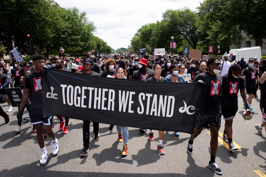 Washington Wizards players, Washington Mystics players and supporters participate in a march to observe Juneteenth, in Washington, DC.