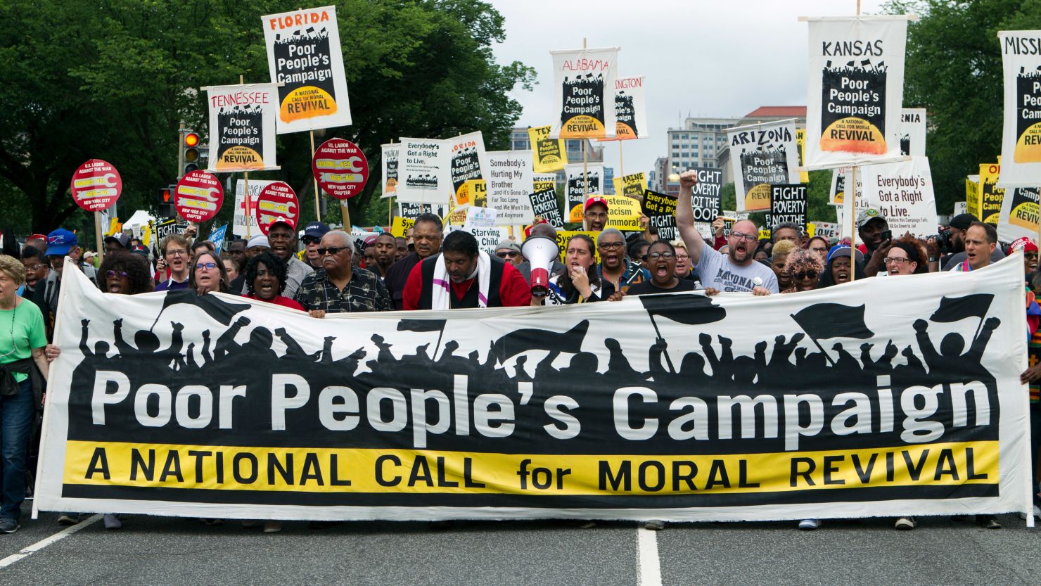 Demonstrators march during the Poor People's Campaign rally in Washington, DC, on June 23, 2018.