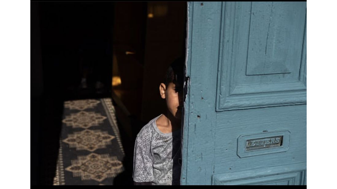 "Even though I photograph space," Christianson says, "I try to bring out personal stories and personal histories, and how people relate to Cape Town." This photo shows a young boy standing at the door of his grandmother's home that was built in 1863. Christianson wrote that when the grandmother was asked if she would ever consider selling, she replied: "Never. When I die, I want to be carried out of this house to my grave."