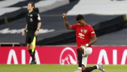 Manchester United's English striker Marcus Rashford (R) takes a knee at the beginning of the English Premier League football match between Tottenham Hotspur and Manchester United at Tottenham Hotspur Stadium in London, on June 19, 2020. (Photo by MATTHEW CHILDS / POOL / AFP) / RESTRICTED TO EDITORIAL USE. No use with unauthorized audio, video, data, fixture lists, club/league logos or 'live' services. Online in-match use limited to 120 images. An additional 40 images may be used in extra time. No video emulation. Social media in-match use limited to 120 images. An additional 40 images may be used in extra time. No use in betting publications, games or single club/league/player publications. /  (Photo by MATTHEW CHILDS/POOL/AFP via Getty Images)