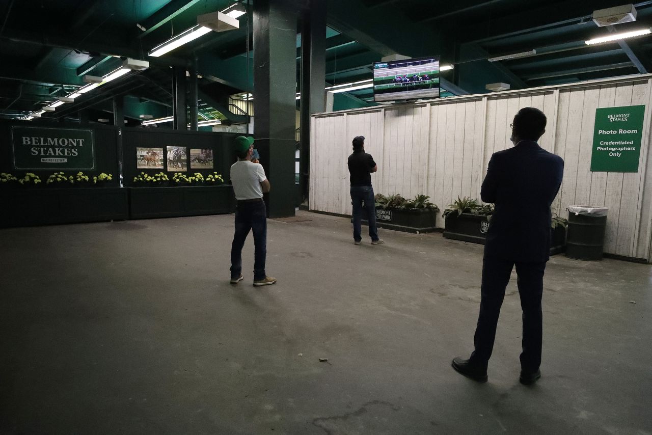 Belmont workers watch an earlier race at the track.