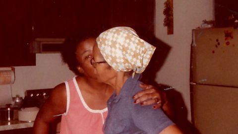 Mae Hazelton gives a kiss to  her grandmother, Nellie Virginia Burkes.