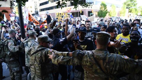 Members of the National Guard formed a barrier to stop protesters near the Bank of Oklahoma Center in Tulsa.