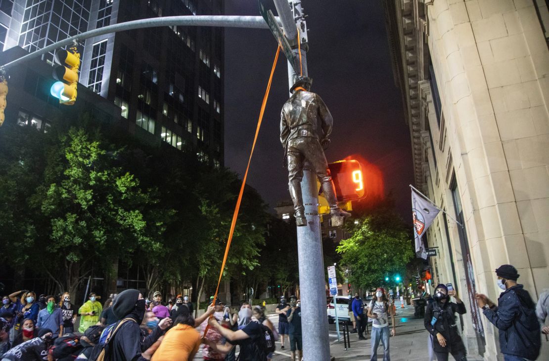 Protesters lynch a figure pulled from the Confederate monument at the State Capitol at the intersection of Salisbury and Hargett Streets in Raleigh, N.C.