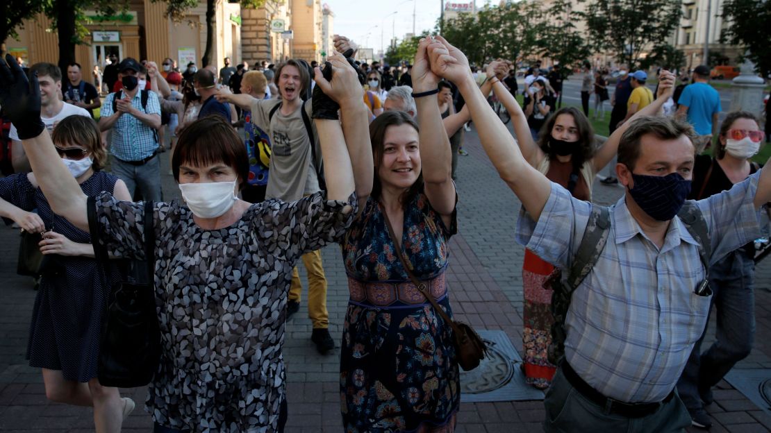 Protesters hold their hands in the air during a rally in Minsk on June 19.