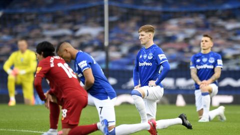 Players and officials take a knee in support of the Black Lives Matter movement  before the Merseyside derby between Everton and Liverpool at Goodison Park. 