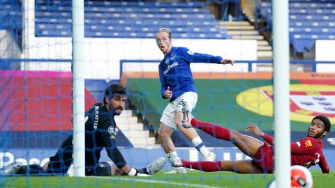 Tom Davies sees his late effort for Everton roll against the post with Liverpool goalkeeper Alisson Becker beaten in the closing stages of the goalless Merseyside derby at an empty Goodison Park.