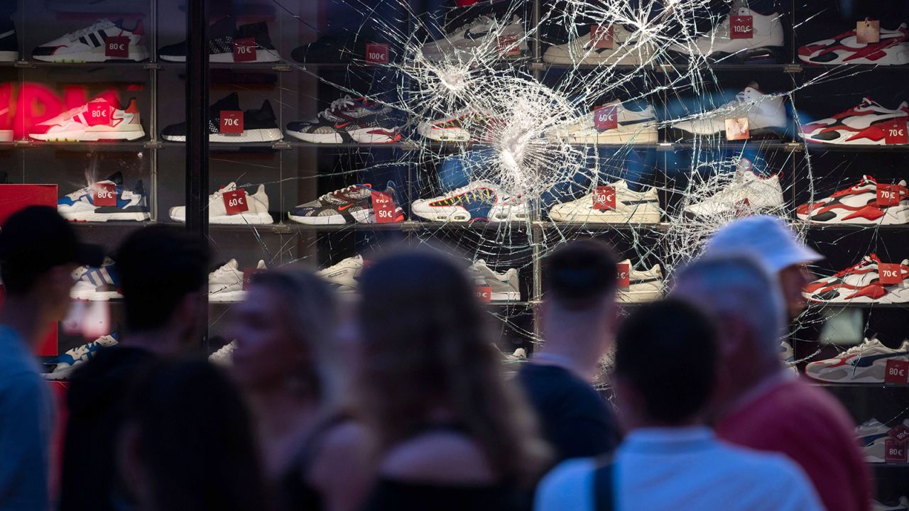 The cracked window of a retail store after riots in Stuttgart, Germany.