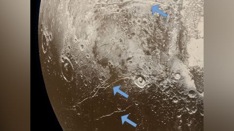 Extensional faults (indicated by arrows) on the surface of Pluto reveal expansion of the dwarf planet's icy crust. This was likely caused by the slow freezing of an ocean beneath the crust.