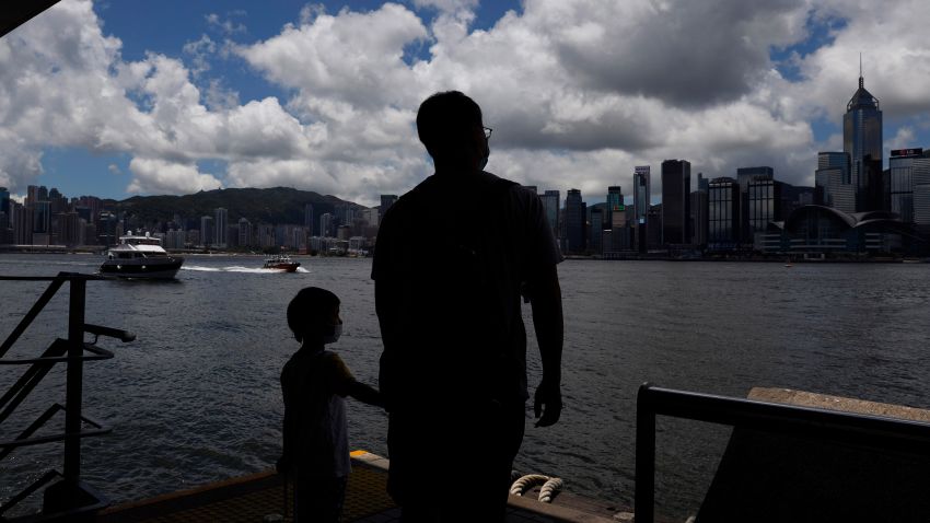 People walk at the waterfront of the Victoria Harbor of Hong Kong, Saturday, June 20, 2020. China's top legislative body has taken up a draft national security law for Hong Kong that has been strongly criticized as undermining the semi-autonomous territory's legal and political institutions. (AP Photo/Kin Cheung)