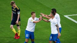 SOCHI, RUSSIA - JUNE 19, 2020: FC Sochi's players Alexander Kokorin (L front), Anton Zabolotny (R) and a teammate celebrate a goal as FC Rostov's Danil Khromov (L back) walks by in a 2019/2020 Russian Premier League Round 23 football match between FC Sochi and FC Rostov at Fisht Stadium. FC Sochi won the match 10-1. The authorities of the Krasnodar Territory (which includes Sochi) have allowed Russian Premier League matches to continue starting from 19 June, on condition on condition that fans fill not more than 10% of a sports venue's capacity and social distancing requirements are observed. Since 31 March, the Krasnodar Territory has been on lockdown in connection with the pandemic of the novel coronavirus disease. Dmitry Feoktistov/TASS (Photo by Dmitry Feoktistov\TASS via Getty Images)