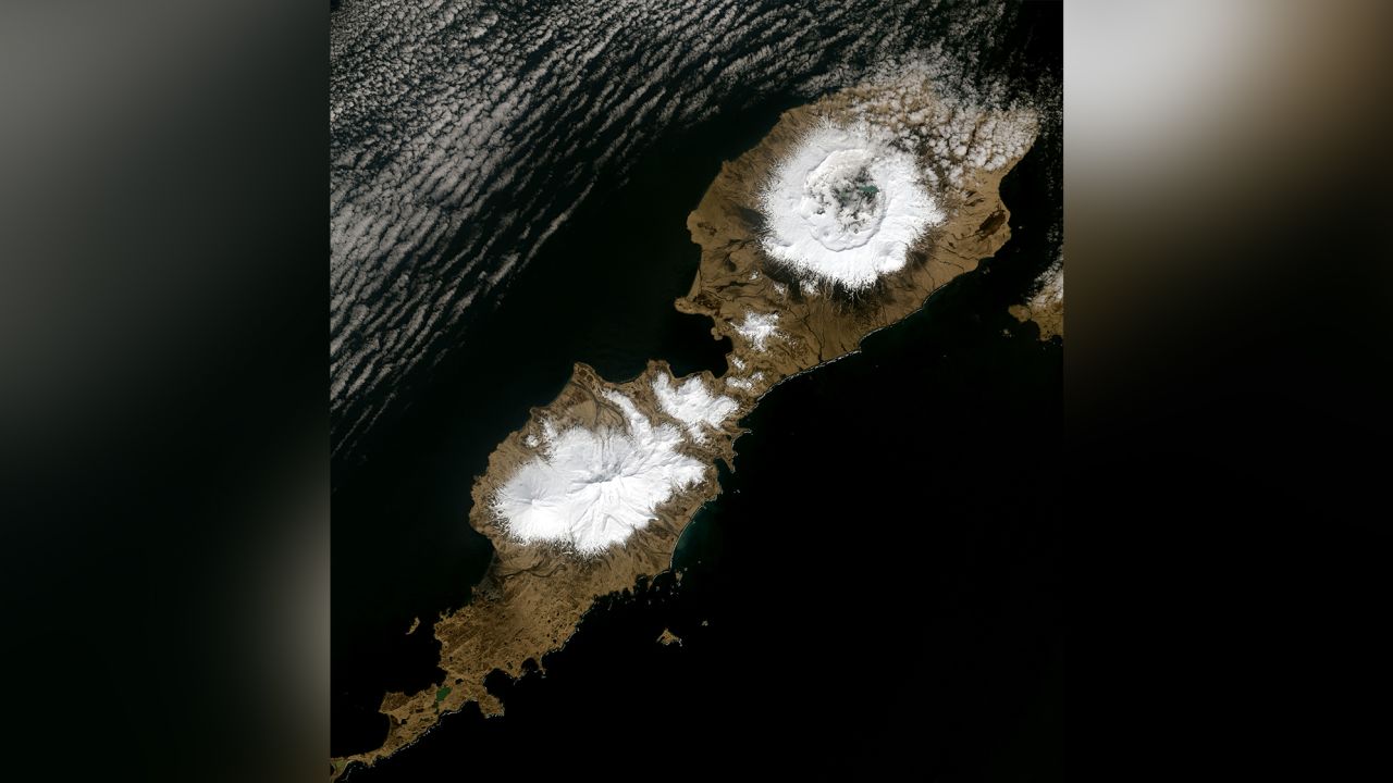 Alaska's Umnak Island  showing the huge, 10-kilometer wide crater (upper right) largely created by the 43 BCE Okmok II eruption at the dawn of the Roman Empire. Landsat-8 Operational Land Imager image from May 3, 2014.
