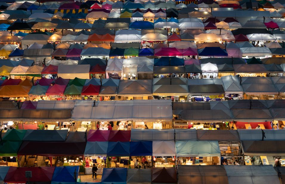 Vendor tents are illuminated at the Rot Fai Market in Bangkok, Thailand, on June 19.