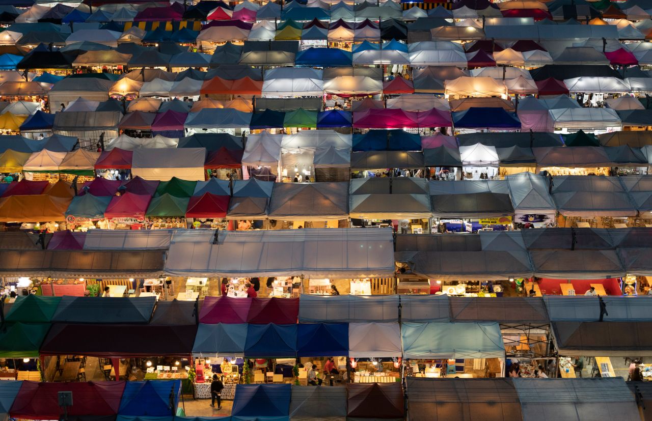 Vendor tents are illuminated at the Rot Fai Market in Bangkok, Thailand, on June 19.