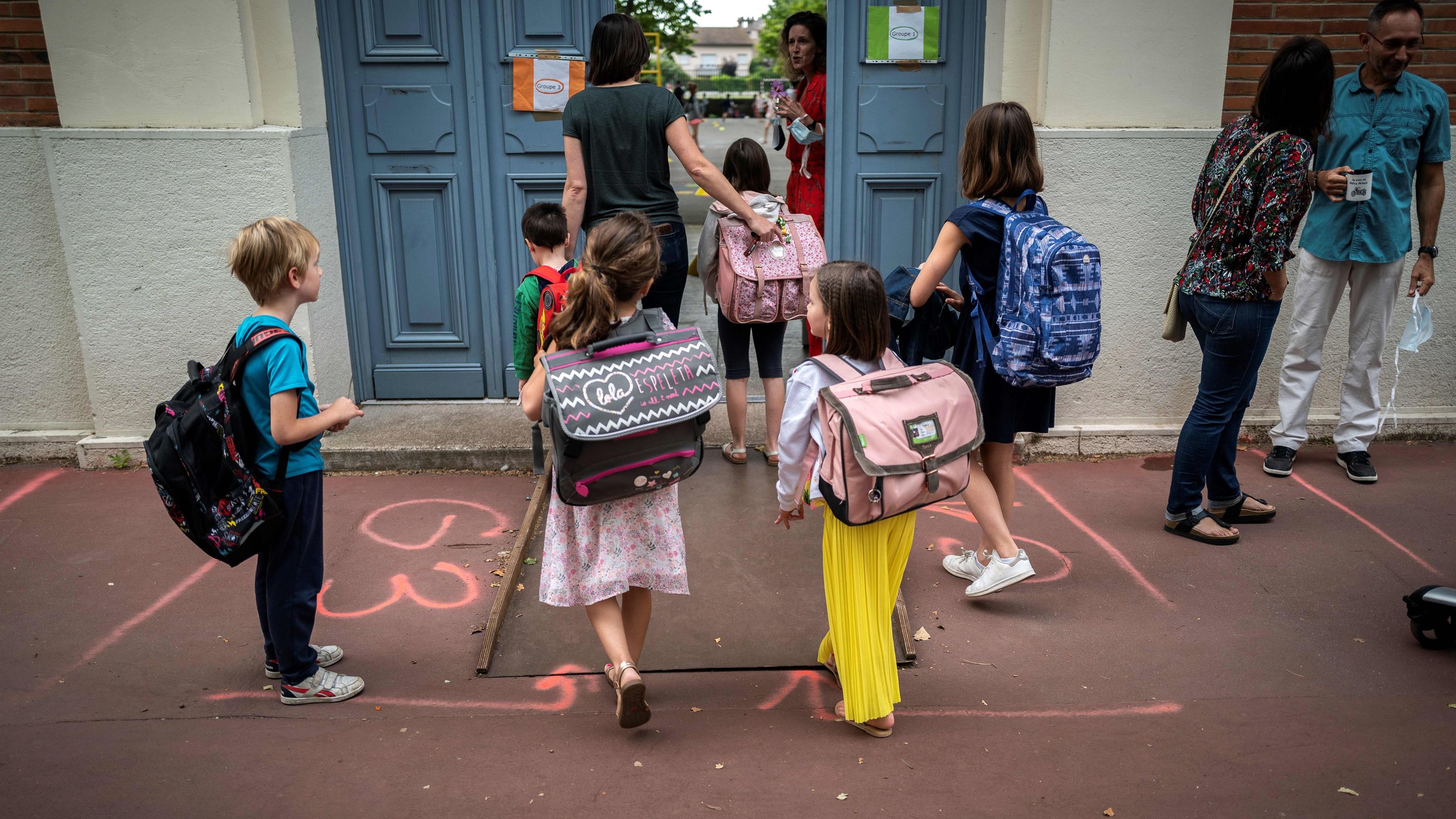 Children arrive at the Jules Julien Elementary School in Toulouse, France, on June 22.