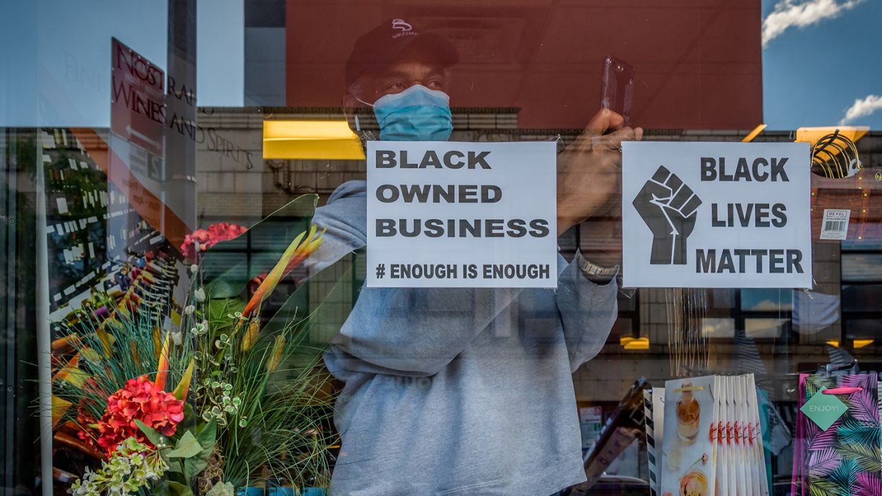 Open storefront in Brooklyn, New York, displaying a Black Owned Business sign. 