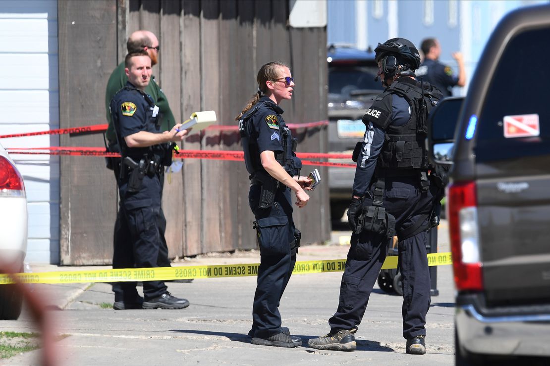 A female police officer and others process the scene of a shooting in Grand Forks, North Dakota, on May 27, 2020.
