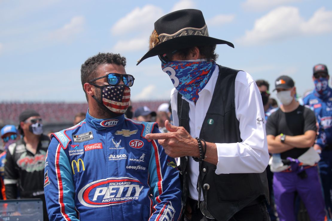 NASCAR Hall of Famer Richard "The King" Petty, right, talks with Bubba Wallace before the NASCAR Cup Series GEICO 500 at Talladega Superspeedway on Monday.