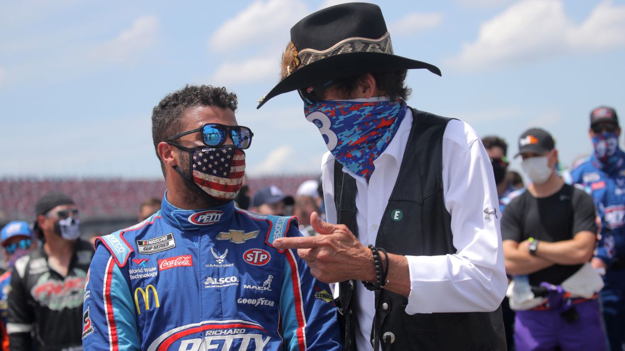 NASCAR Hall of Famer Richard "The King" Petty, right, talks with Bubba Wallace before the NASCAR Cup Series GEICO 500 at Talladega Superspeedway on Monday.