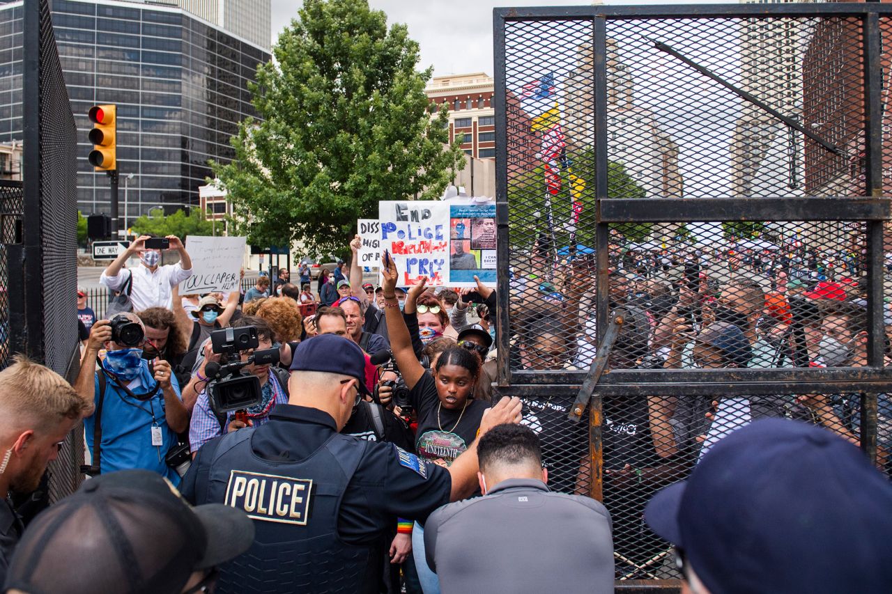 Protesters try to enter a gate leading to the BOK Center, where President Donald Trump <a href=