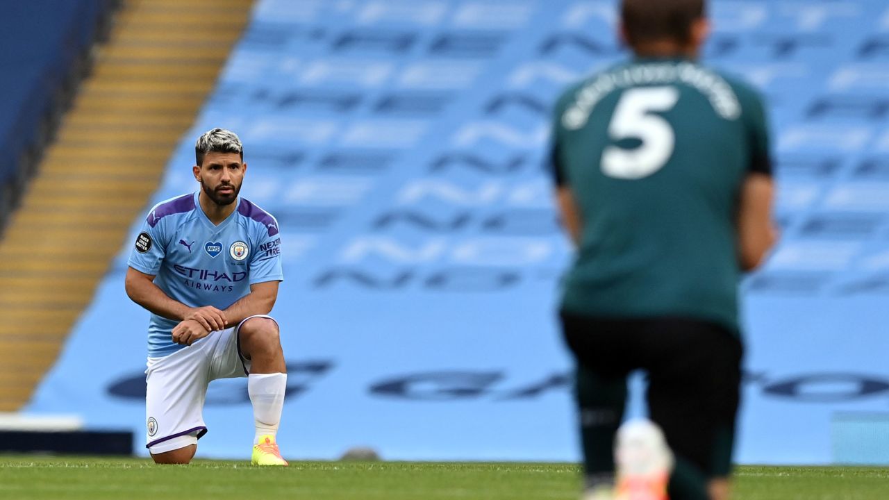 Manchester City striker Sergio Aguero(L) and Burnley defender James Tarkowski take a knee in support of the Black Lives Matter movement.