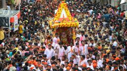 Indian Hindu devotees pull a chariot carrying the icon of Lord Balaram, brother of  Lord Jagannath, in Raipur area during the 142nd annual Rath Yatra of Lord Jagannath, in Ahmedabad on July 4, 2019. - Idols of Lord Jagannath, his Sister Subhadra and his Brother, Balaram  are taken out in a procession from Lord Jagannath Temple once a year. According to mythology, the Ratha Yatra dates back some 5,000 years when Hindu god Krishna, along with his older brother Balaram and sister Subhadra, were pulled on a chariot from Kurukshetra to Vrindavana by Krishna's devotees. (Photo by SAM PANTHAKY / AFP)        (Photo credit should read SAM PANTHAKY/AFP via Getty Images)