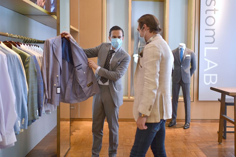Trevor Shimpfky helps a customer select a suit from Custom LAB in New York City on June 22.