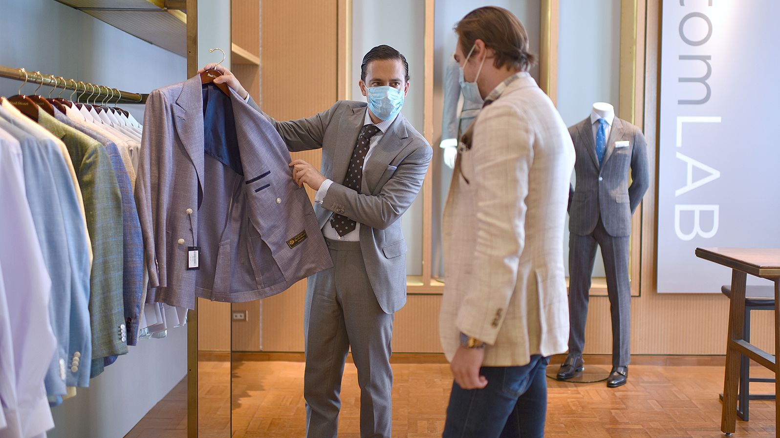 Trevor Shimpfky helps a customer select a suit from Custom LAB in New York City on June 22.