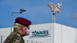 GUETERSLOH, GERMANY - JUNE 19: A Member of the Bundeswehr, the German armed forces, stands in front of the Toennies meat packing plant during the coronavirus pandemic in Rheda-Wiedenbrueck on June 19, 2020 near Guetersloh, Germany. Hundreds of workers at the plant have so far tested positive for the virus, which has led authorities to shut school and child day care centers in the region and place 7,000 people in quarantine. The Bundeswehr began assisting with the testing at the Toennies facility today and will stay on until June 23. (Photo by Sascha Schuermann/Getty Images)