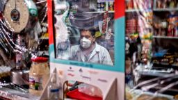 A seller waits for customers behind a protective nylon shield placed to prevent the spread of the new coronavirus, COVID-19, at Iztapalapa market, in Mexico City on June 22, 2020. - The spread of COVID-19 is accelerating across Latin America, with Mexico, Peru and Chile also hard-hit as death tolls soar and healthcare facilities are pushed toward collapse. (Photo by Pedro Pardo/AFP/Getty Images)